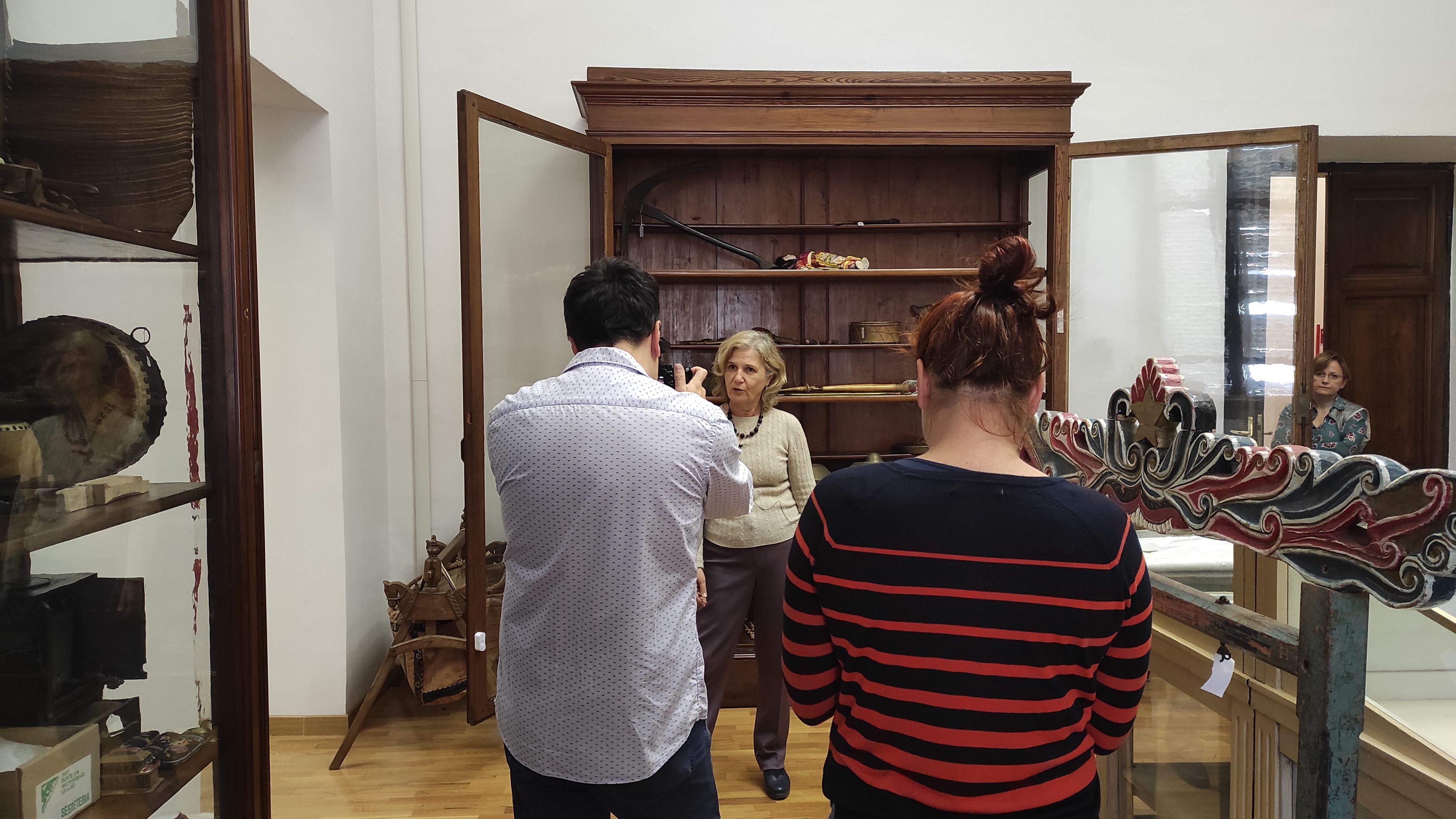 Sandy dunes with distant mountains under a hazy sky